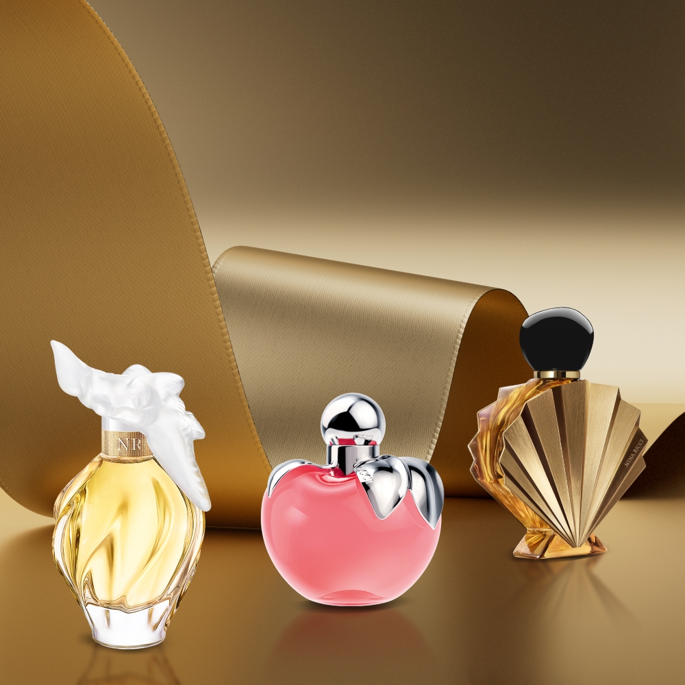 Nina Ricci Air Du Temps, Nina and Venus De Nina Ricci perfumes displayed against a gold background.