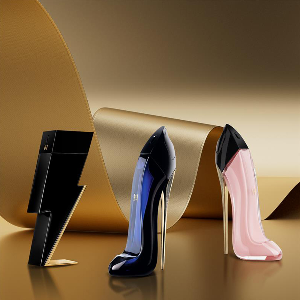 Carolina Herrera Good Girl, Good Girl Blush and Bad Boy perfumes displayed on a gold background.