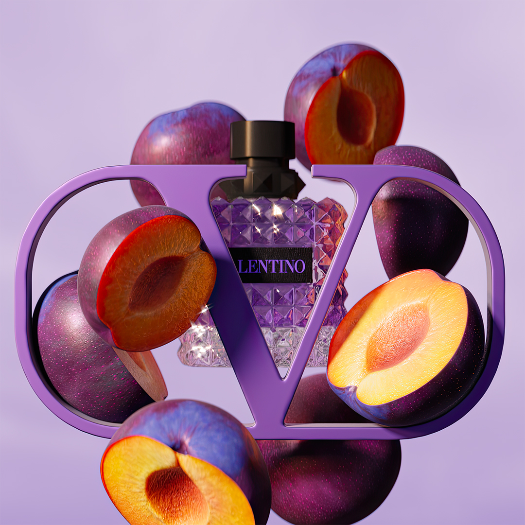 Sliced prumes levitating, Valentino Born in Roma Purple Melancholia perfume and the Valentino logo.